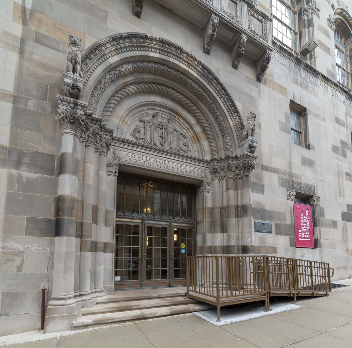 Facade of the new york state education department building with its ornately carved archway and entrance doors.